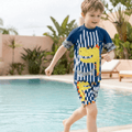 Bright boys' swimwear featuring a cartoon dinosaur design with UV protection from NOVA, suitable for kids' beach and pool fun.