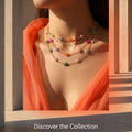 A promotional graphic for floral chain necklaces, featuring a model wearing three layered necklaces with colorful flowers and beads. The image includes text overlays reading 'Mix, match, and make a statement with our vibrant floral chains.