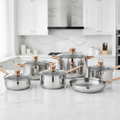 A set of stainless steel cookware pots and lids with shiny gold-toned handles and lids, arranged on a clean white background.