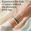 A close-up of a person's wrist wearing a stack of slim bangle bracelets in white, gold, black, mint green, and lavender. Large promotional text appears above, and a pink 'SHOP NOW' button is at the bottom on a soft cream and mint background.