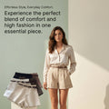 A woman models a light beige high-waisted A-line shirt and shorts set with a matching belt. To her left, a display stand shows the same shorts in multiple colors (white, navy, gray).