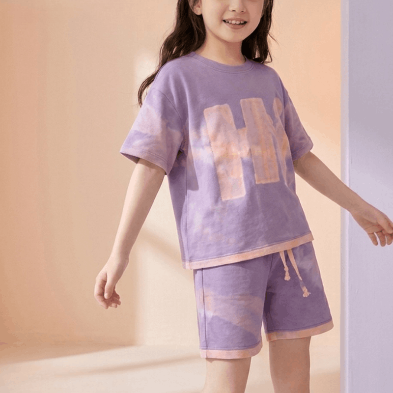 Girls sports casual look set by NOVA for ages 7-11, featuring a trendy summer outfit with a T-shirt and shorts.