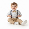 Child wearing suspenders and a bow tie on a white background